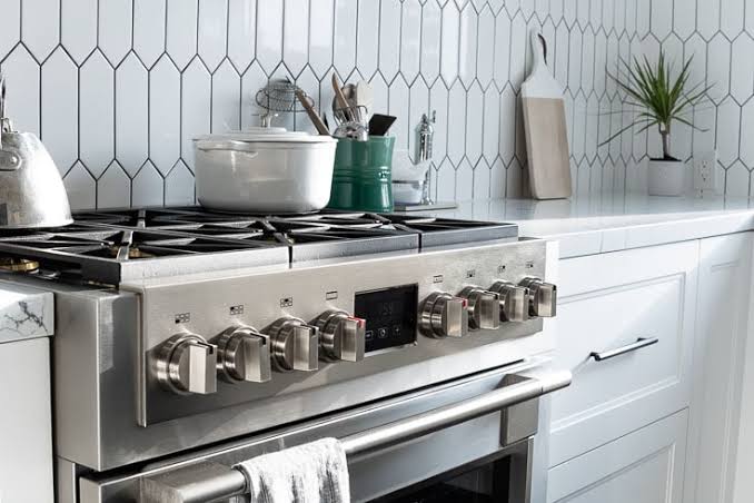 Fulgor Milano 48 inch professional range with griddle in an open-plan kitchen